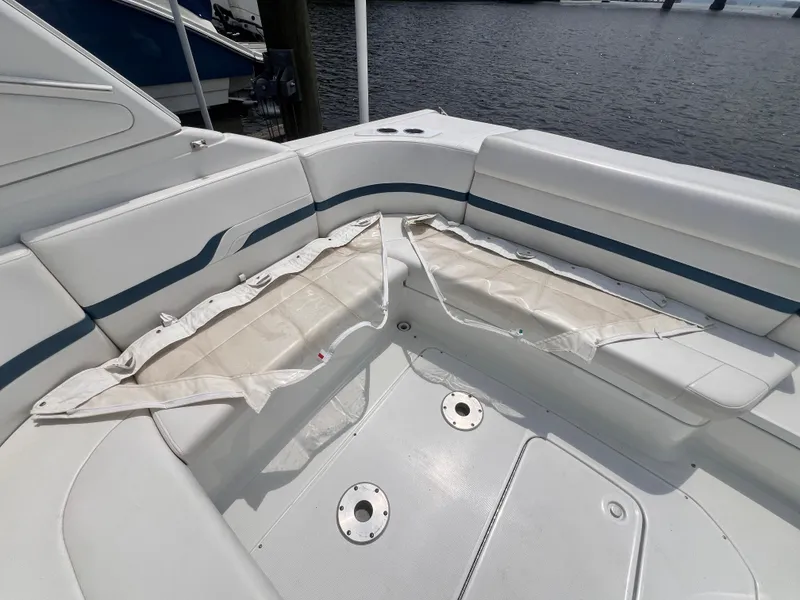 Slide: The Image of 2005 Formula 330 Sun Sport boat interior with white seating and storage compartments. - 39