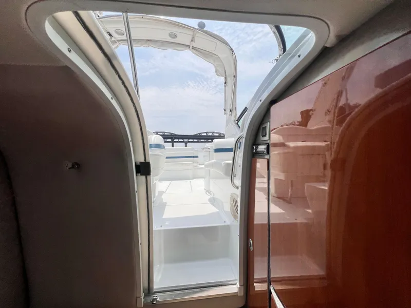 Slide: The Image of Interior view of a 2005 Formula 330 Sun Sport boat, showing cabin entrance and seating area. - 41