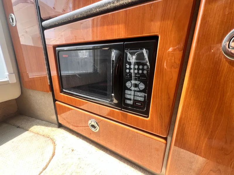Slide: The Image of Built-in microwave in 2005 Formula 330 Sun Sport boat interior with wood paneling. - 42