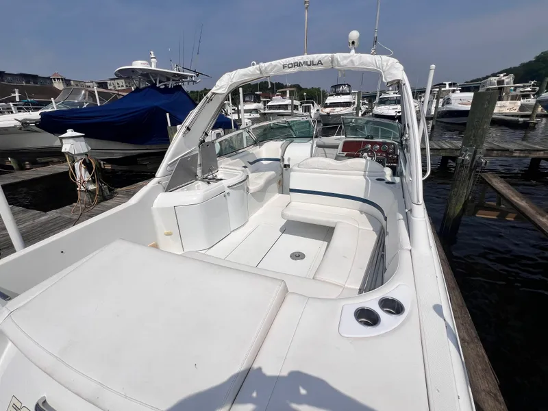 Slide: The Image of 2005 Formula 330 Sun Sport boat docked at marina, featuring spacious seating and sleek design. - 6