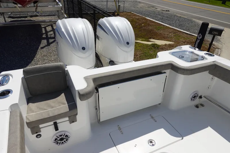 Slide: The Image of 2026 Sea Hunt Gamefish 27 boat deck with dual engines and seating area. - 10