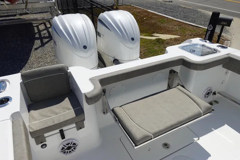 Slide: The Image of 2026 Sea Hunt Gamefish 27 boat interior with dual engines and cushioned seating. - 11