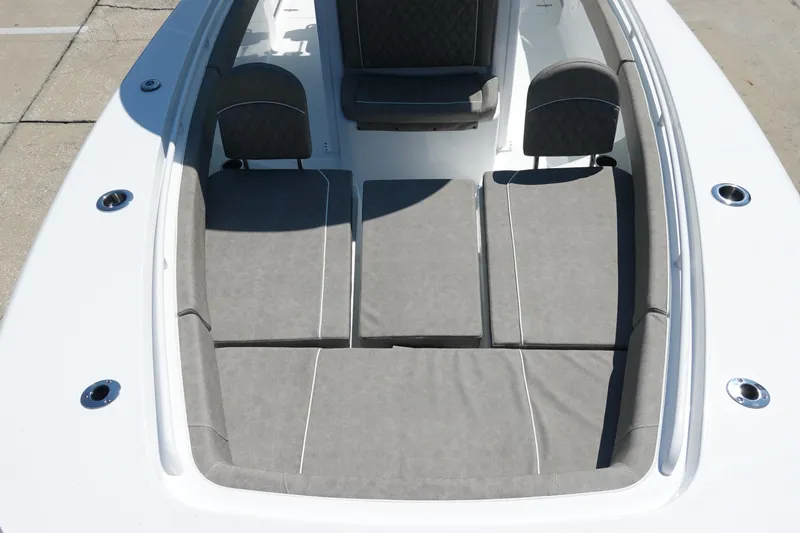 Slide: The Image of 2026 Sea Hunt Gamefish 27 boat interior with gray cushioned seating. - 25