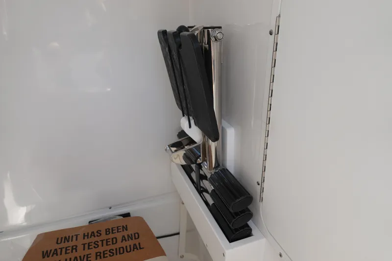 Slide: The Image of 2026 Sea Hunt Gamefish 27 boat interior detail with folded ladder and testing label. - 33