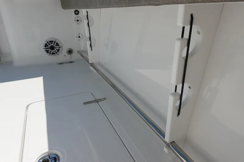 Slide: The Image of Interior view of 2026 Sea Hunt Gamefish 27 boat, featuring storage and speaker. - 38