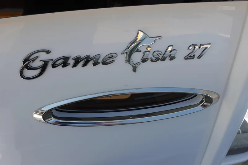 Slide: The Image of Sea Hunt Gamefish 27 boat emblem, 2026 model, sleek chrome design. - 42