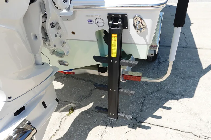 Slide: The Image of Rear view of 2026 Sea Hunt Gamefish 27 boat with ladder and motor details. - 8