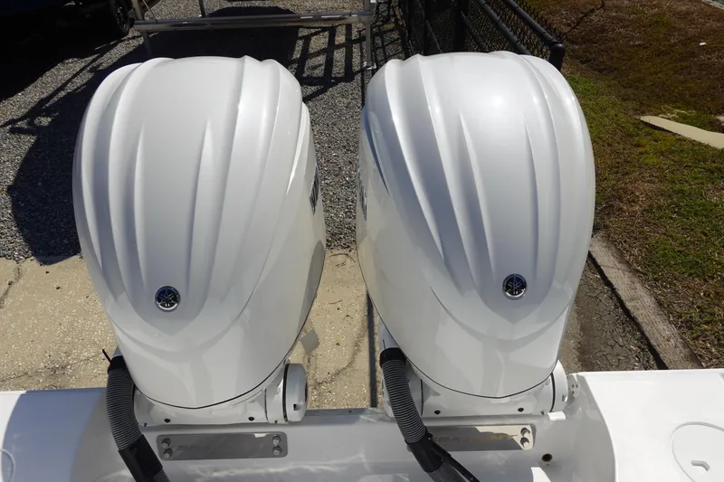 Slide: The Image of Twin outboard engines on a 2026 Sea Hunt Gamefish 27 boat, viewed from above. - 9