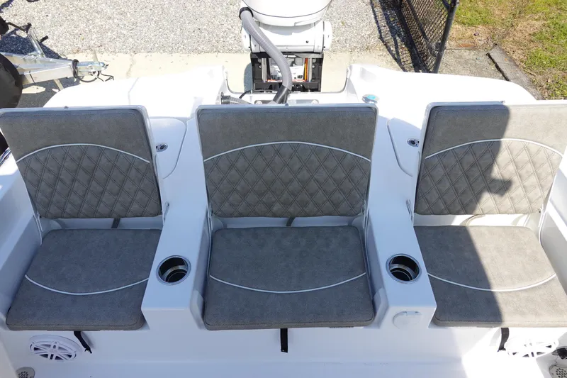 Slide: The Image of 2026 Sea Hunt BX 25 FS boat with three cushioned seats and cup holders. - 10