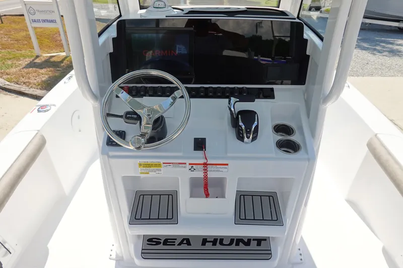Slide: The Image of 2026 Sea Hunt BX 25 FS boat console with steering wheel and Garmin display. - 17