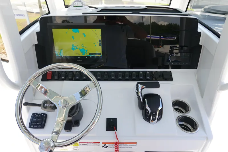 Slide: The Image of 2026 Sea Hunt BX 25 FS boat dashboard with steering wheel and navigation display. - 18