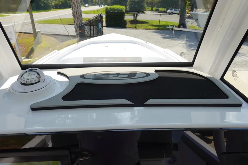 Slide: The Image of 2026 Sea Hunt BX 25 FS boat dashboard with compass and logo. - 20