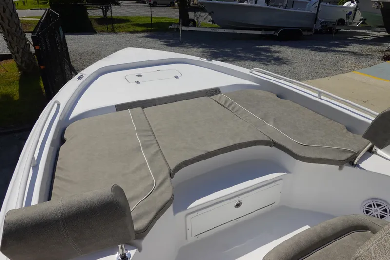 Slide: The Image of 2026 Sea Hunt BX 25 FS boat interior with cushioned seating and storage compartment. - 23