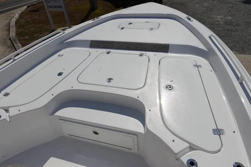 Slide: The Image of 2026 Sea Hunt BX 25 FS boat deck with storage compartments and ruler. - 25
