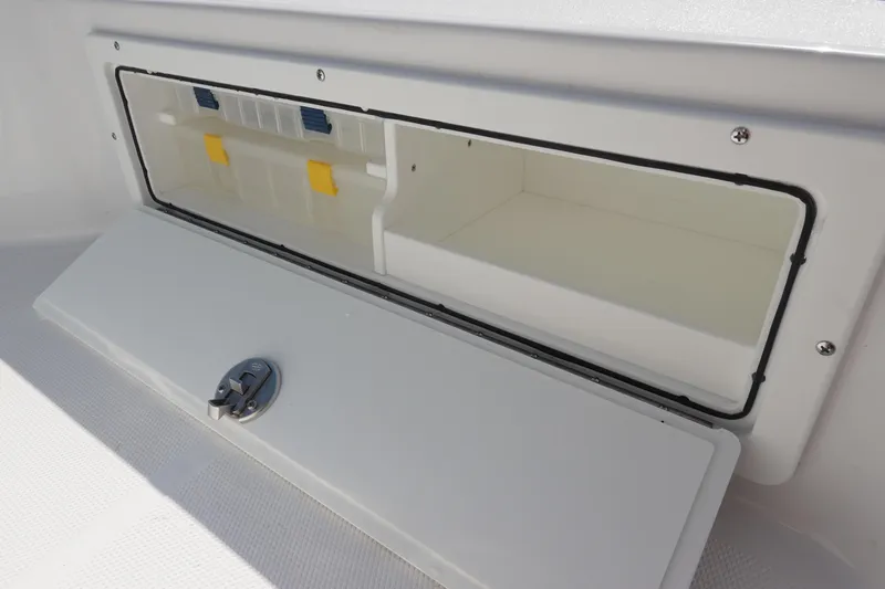 Slide: The Image of Storage compartment on 2026 Sea Hunt BX 25 FS boat, featuring secure latch and organized interior. - 26