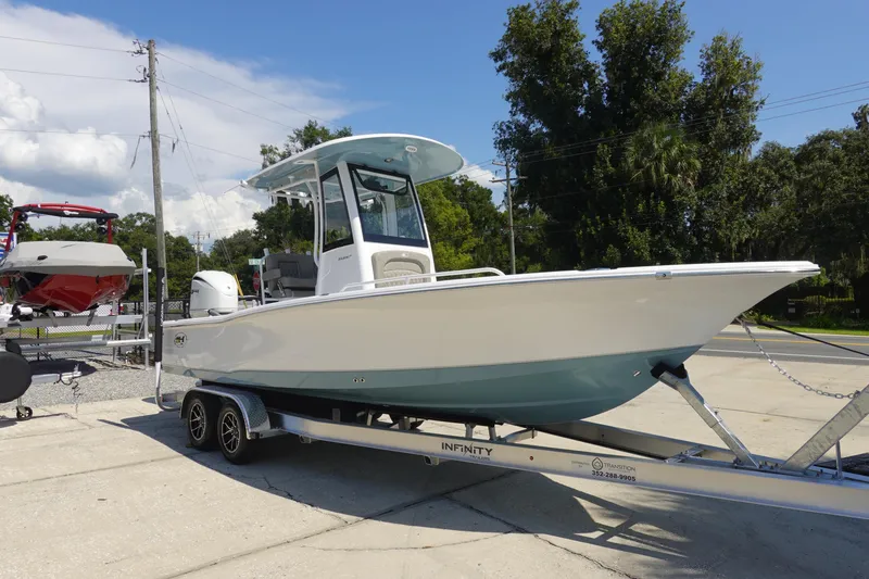 Slide: The Image of 2026 Sea Hunt BX 25 FS boat on trailer, parked outdoors under clear sky. - 3