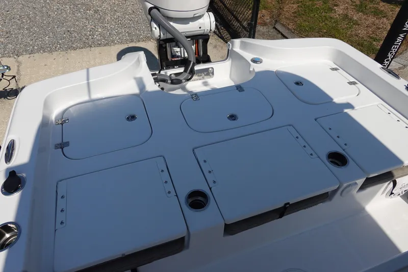 Slide: The Image of 2026 Sea Hunt BX 25 FS boat deck with storage compartments and motor. - 8