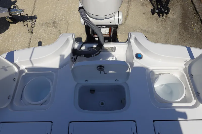 Slide: The Image of 2026 Sea Hunt BX 25 FS boat deck with storage compartments and motor. - 9