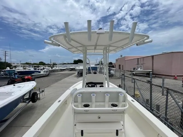 Slide: The Image of 2025 Pathfinder 2200 TRS boat with T-top, docked under a partly cloudy sky. - 15