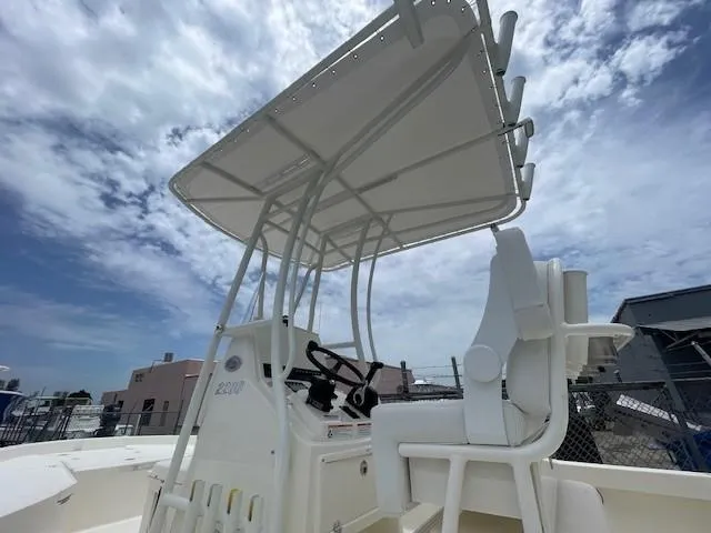 Slide: The Image of 2025 Pathfinder 2200 TRS boat with T-top under a partly cloudy sky. - 7