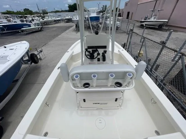 Slide: The Image of 2025 Pathfinder 2200 TRS boat interior with steering console and rod holders, docked at marina. - 8
