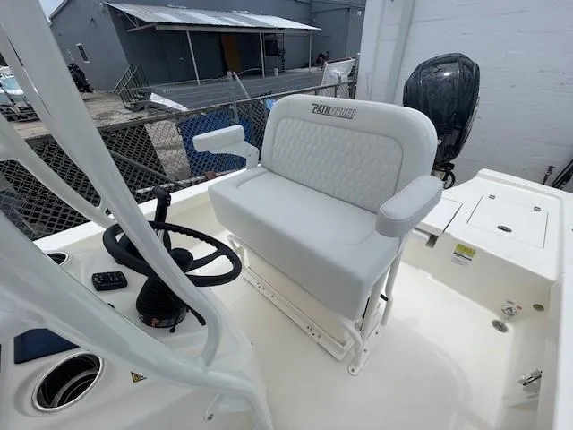 Slide: The Image of 2025 Pathfinder 2200 TRS boat interior with steering wheel and cushioned seating. - 9