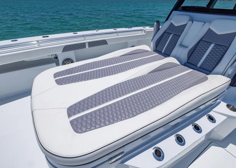 Slide: The Image of Invincible 38 Catamaran 2026 with luxurious seating, ocean backdrop. - 14