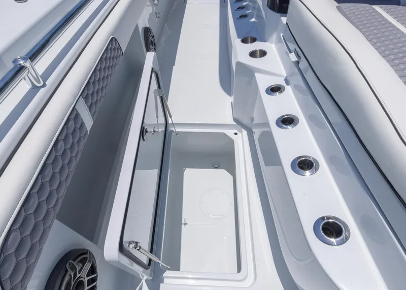 Slide: The Image of 2026 Invincible 38 Catamaran interior with open storage compartment and seating area. - 16