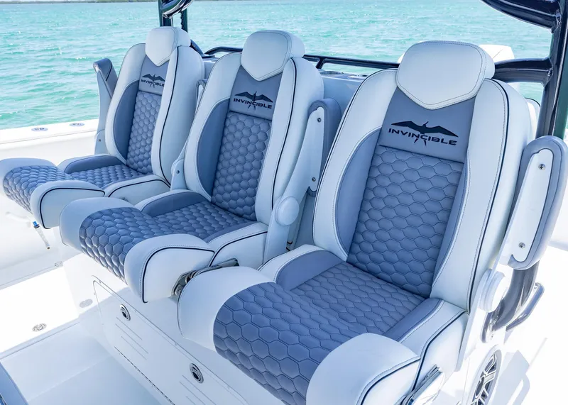Slide: The Image of Luxury seating on 2026 Invincible 38 Catamaran, featuring stylish blue and white upholstery. - 20