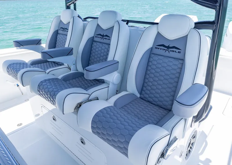 Slide: The Image of 2026 Invincible 38 Catamaran luxury seating with gray and white upholstery on open water. - 21