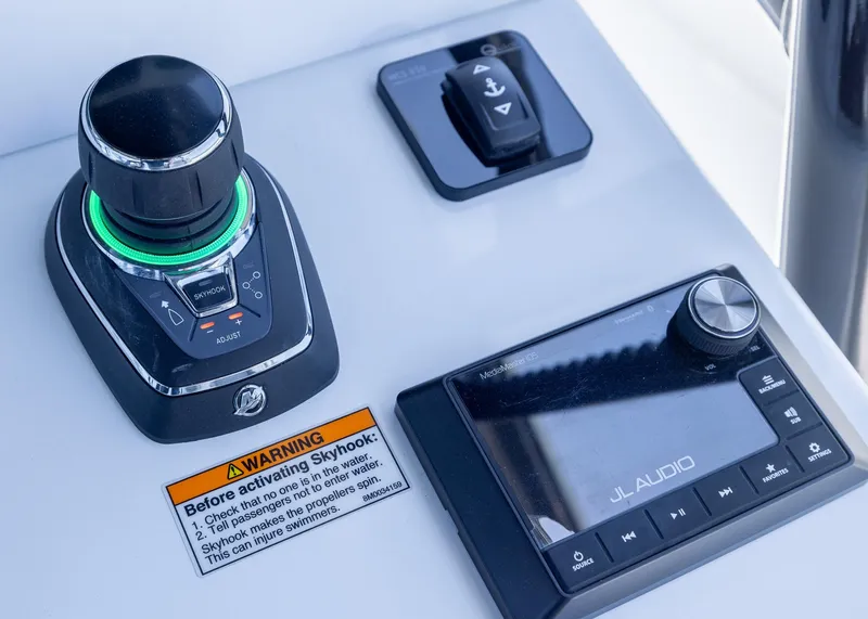 Slide: The Image of Control panel of 2026 Invincible 38 Catamaran featuring joystick and JL Audio system. - 24