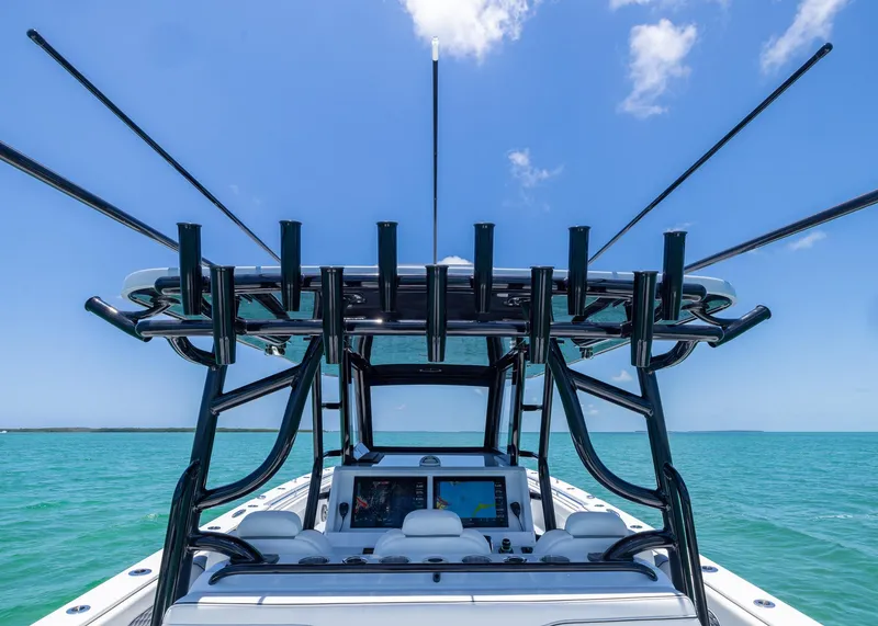 Slide: The Image of 2026 Invincible 38 Catamaran on turquoise water, featuring advanced navigation equipment and rod holders. - 29