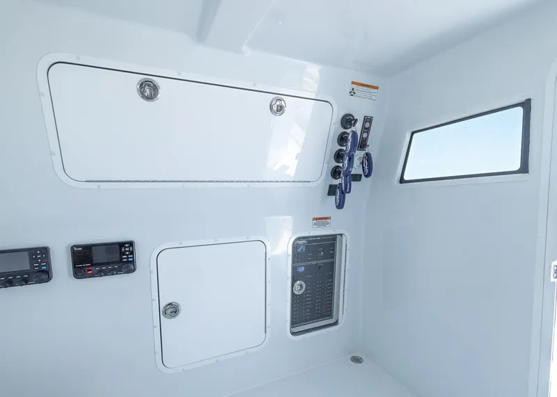 Slide: The Image of 2026 Invincible 38 Catamaran interior with control panels and storage compartments. - 37