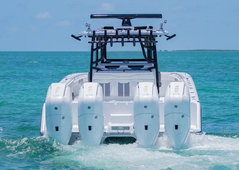 Slide: The Image of 2026 Invincible 38 Catamaran with four engines cruising on clear blue water. - 42