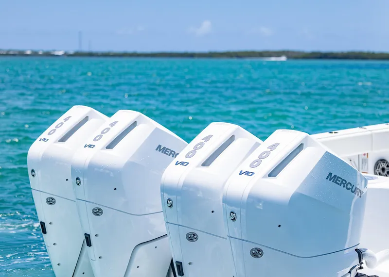 Slide: The Image of Triple Mercury outboard engines on 2026 Invincible 38 Catamaran in turquoise waters. - 46