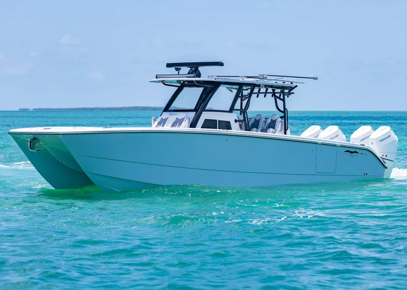 Slide: The Image of 2026 Invincible 38 Catamaran cruising on clear blue ocean waters. - 47