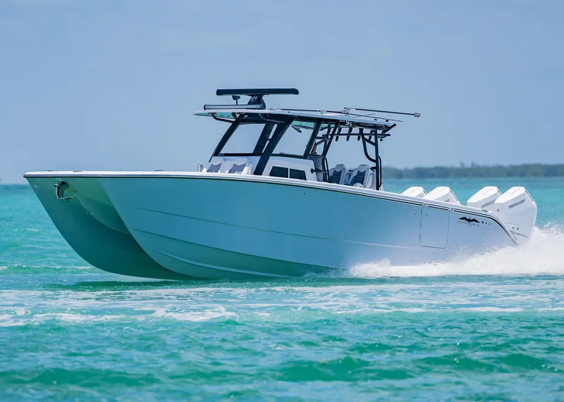 Slide: The Image of 2026 Invincible 38 Catamaran cruising on turquoise waters. - 49