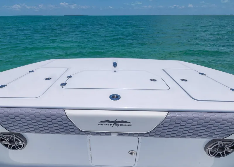 Slide: The Image of 2026 Invincible 38 Catamaran on turquoise ocean waters under clear blue sky. - 6