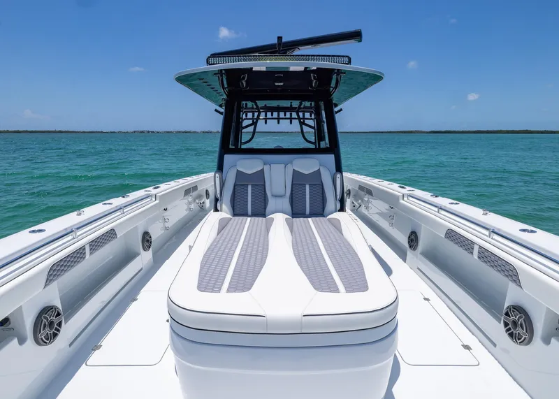 Slide: The Image of 2026 Invincible 38 Catamaran on turquoise water, showcasing sleek design and spacious deck. - 7