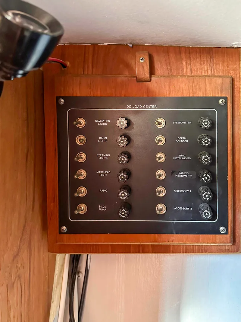 Slide: The Image of Control panel of a 1983 Sailboat Racing Sloop with labeled switches and dials. - 11
