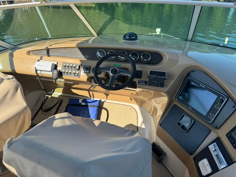 Slide: The Image of 2001 Carver 450 Voyager Pilothouse helm with steering wheel, controls, and navigation equipment. - 14