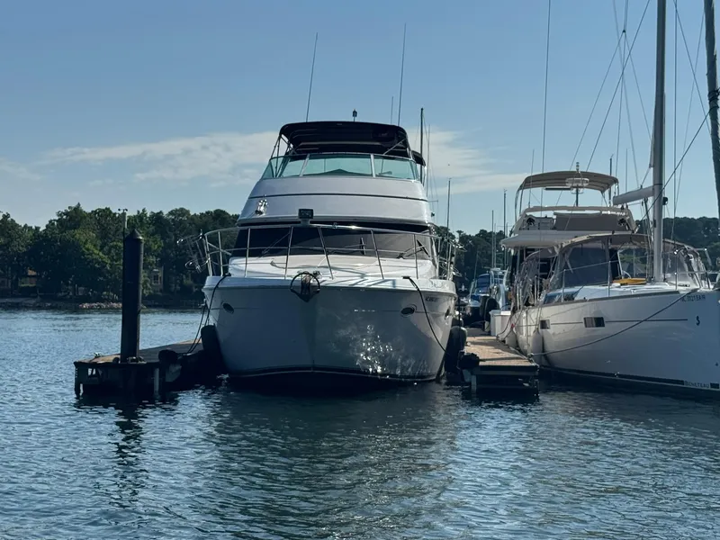 Slide: The Image of 2001 Carver 450 Voyager Pilothouse yacht docked at marina, sunny day. - 2