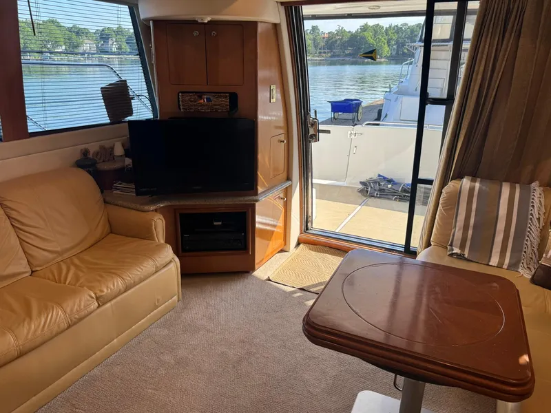 Slide: The Image of Interior of 2001 Carver 450 Voyager Pilothouse with cozy seating and waterfront view. - 21