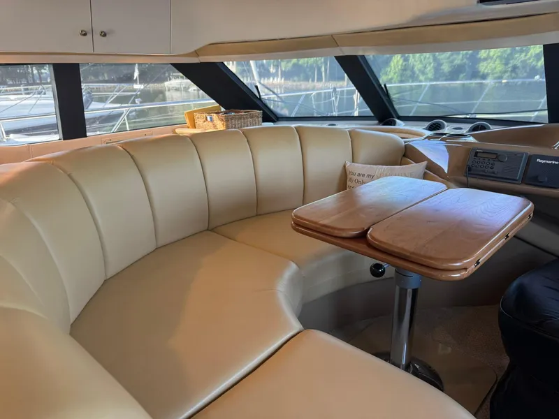 Slide: The Image of Luxurious interior of 2001 Carver 450 Voyager Pilothouse with leather seating and wooden table. - 27