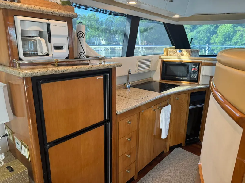 Slide: The Image of Luxurious kitchen in 2001 Carver 450 Voyager Pilothouse with appliances and wood cabinetry. - 29