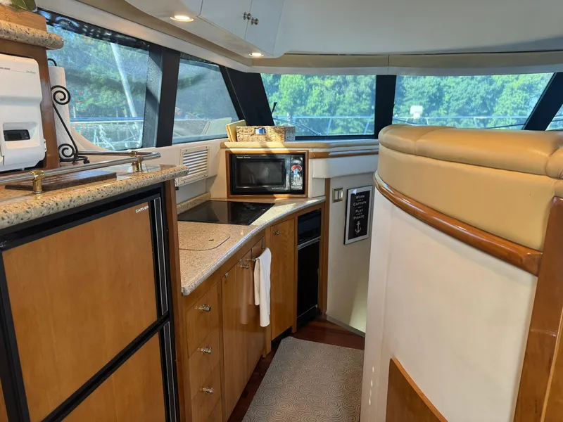 Slide: The Image of Interior of 2001 Carver 450 Voyager Pilothouse with kitchen amenities and modern design. - 30
