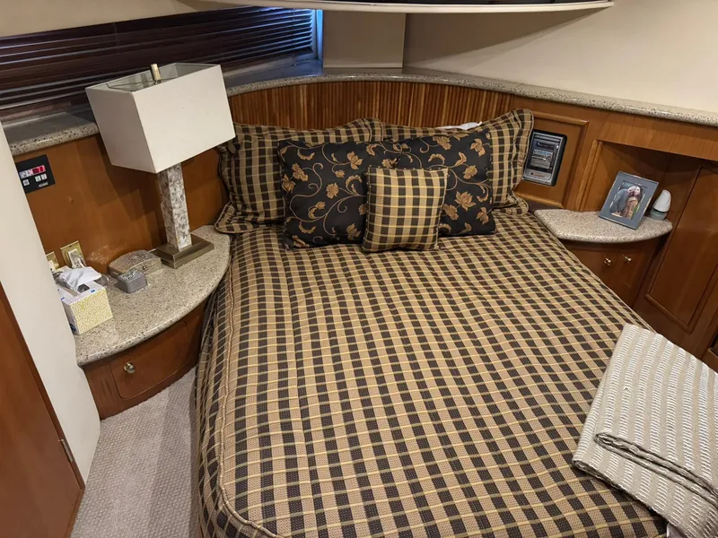 Slide: The Image of Luxurious bedroom in 2001 Carver 450 Voyager Pilothouse with checkered bedding and elegant decor. - 34