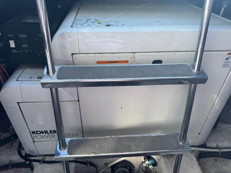 Slide: The Image of Engine room of 2001 Carver 450 Voyager Pilothouse with Kohler power system and ladder. - 44