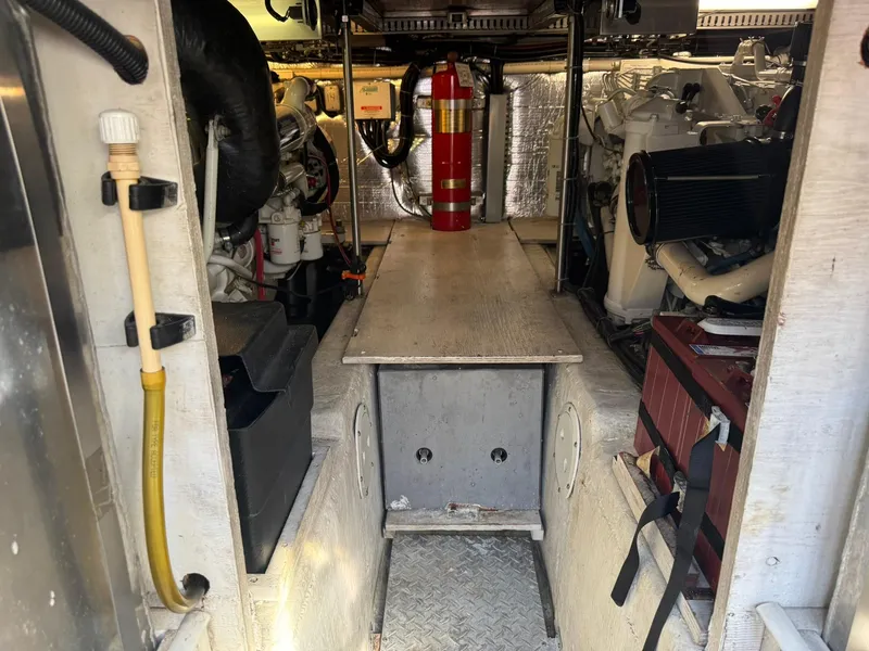 Slide: The Image of Engine room of a 2001 Carver 450 Voyager Pilothouse with visible equipment and fire extinguisher. - 46