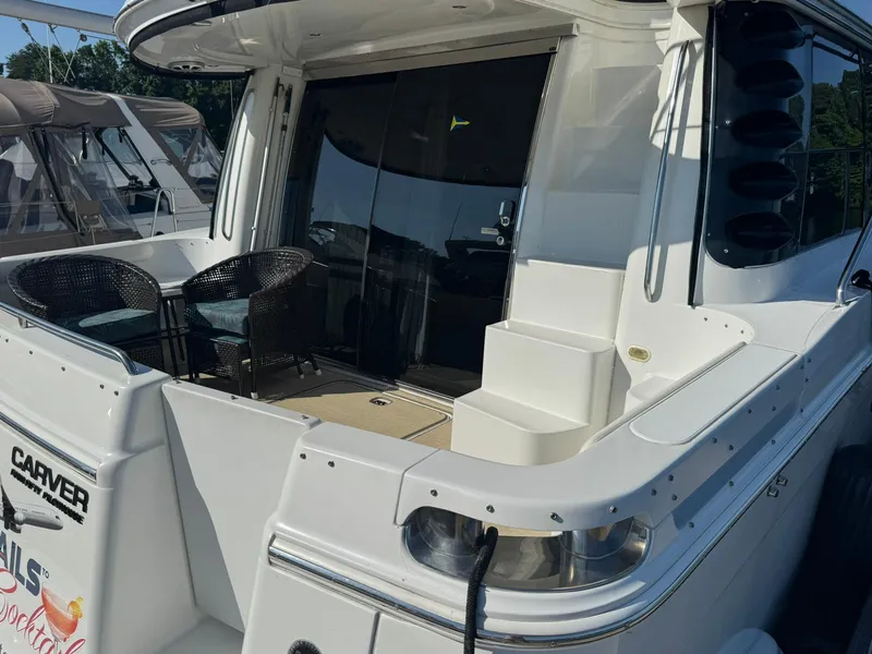Slide: The Image of 2001 Carver 450 Voyager Pilothouse yacht with outdoor seating and sleek design. - 6